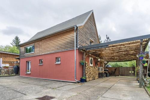 a large red building with a brown roof at Chalet Kunterbunt in Langenwetzendorf