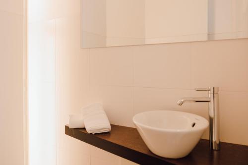 a bathroom with a white sink and a mirror at Residence Hotel Alpinum in Campo Tures