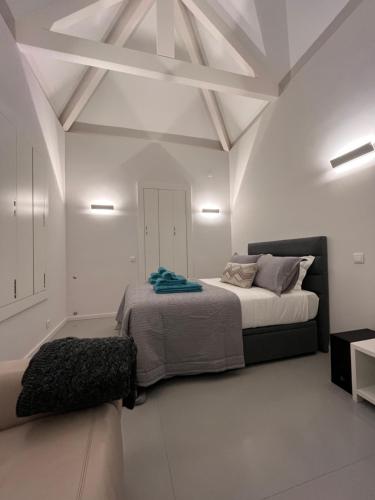 a bedroom with two beds in a white room at JM Alojamento local no Porto in Porto