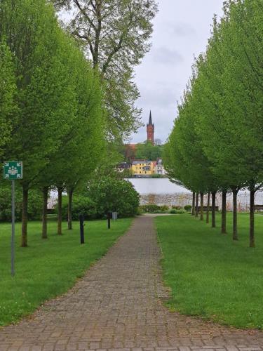 a brick path in a park with trees and a building at Ferienwohnung Familie Windt in Feldberg