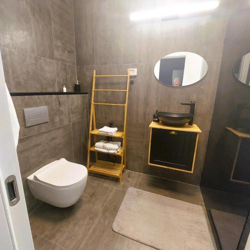 a bathroom with a toilet and a sink and a mirror at stylish apartment by the SEA in Ashdod