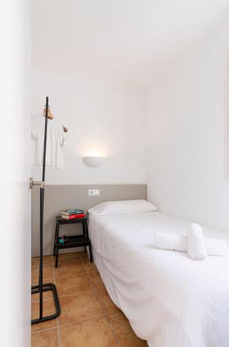 a bedroom with two beds and a table with a lamp at Apartamentos CASA MAREA Calella Palafrugell con Parking in Calella de Palafrugell