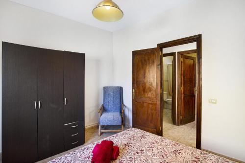a bedroom with a bed and a blue chair at Villa Palomino in Gáldar