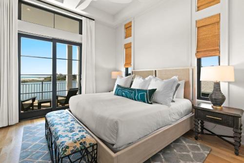a bedroom with a bed with a table and a window at 283 Lakeview Drive in Seagrove Beach