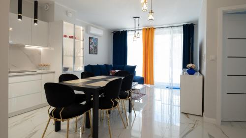 a kitchen and dining room with a table and chairs at Laguna Beskidów, Sun & Snow in Zarzecze