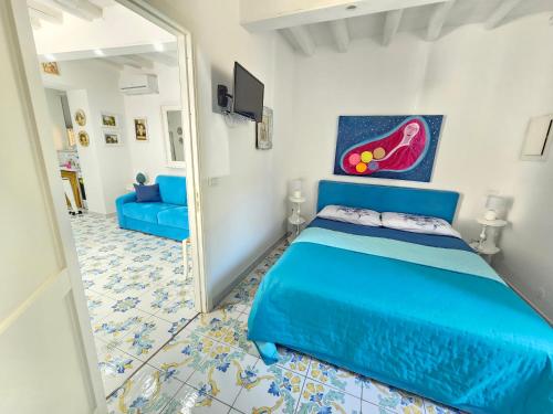 a bedroom with a blue bed and a mirror at Casa Tina indipendente a 2 passi dal centro al foro italico e al nuovo porto marina bay in Palermo