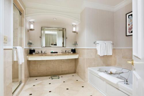 a bathroom with a tub and a sink and a mirror at The Ballantyne, a Luxury Collection Hotel, Charlotte in Charlotte