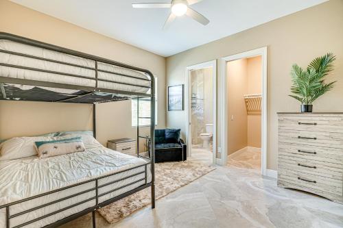a bedroom with a bunk bed and a bathroom at Lakefront Home with Private Dock in Cape Coral! in Matlacha