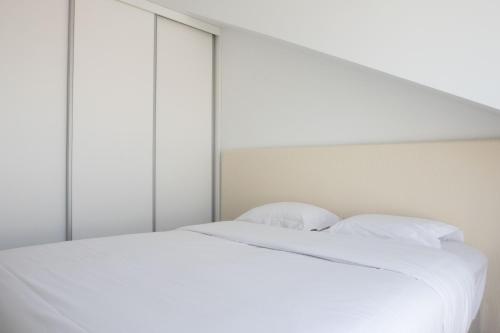 a white bed with white sheets and pillows at Oscar Concept Apartments in Lisbon