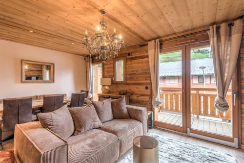 un salon avec un canapé et une table dans l'établissement Duplex des Charmoz - Welkeys, à Megève