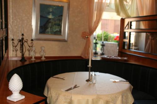 a dining room with a table with a candle on it at Restaurant Orakel in Oberstenfeld