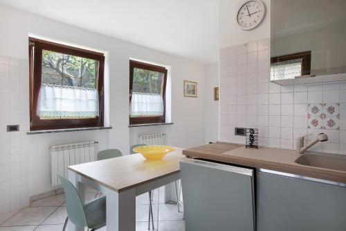 a kitchen with a table and a counter top at Reditus in Aosta