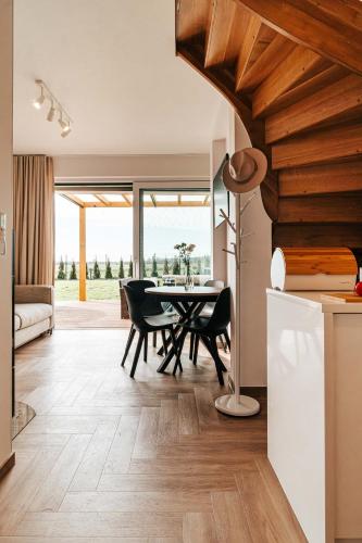 a kitchen and dining room with a table and chairs at Sea & Sun in Wierzchucino