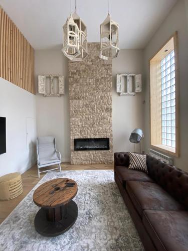 a living room with a brown couch and a table at Cornelia Suites 03 in Santander