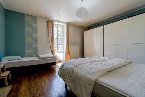 a bedroom with a large bed and a window at Gite de charme Le Clos Michel 14 personnes piscine in Briord