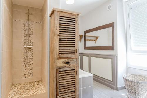 a bathroom with a walk in shower next to a mirror at Gite de charme Le Clos Michel 14 personnes piscine in Briord