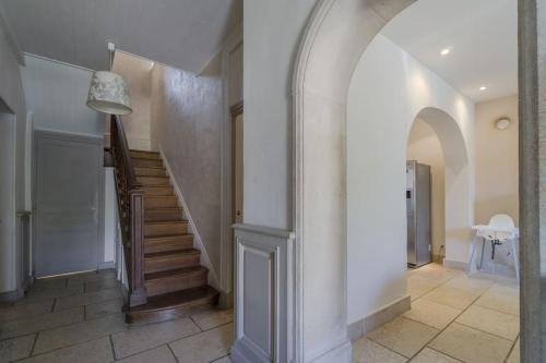 a hallway with a staircase in a house at Gite de charme Le Clos Michel 14 personnes piscine in Briord
