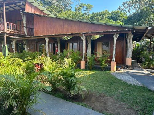 a house with a garden in front of it at Casa Torre Eco- Lodge in Fortuna