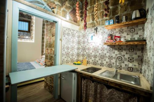 a small kitchen with a sink and a shower at The Cave in Naples