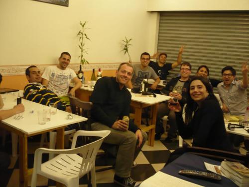 
a large group of people sitting around a table at Hostel Vergueiro in Sao Paulo
