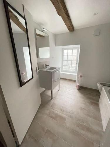 a bathroom with a sink and a mirror on the wall at Charmante maison à Evran proche Dinan et St Malo. in Évran