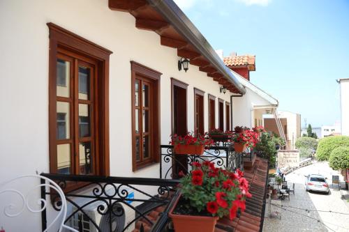 a balcony with flowers and plants on a building at Villa Castriota in Krujë