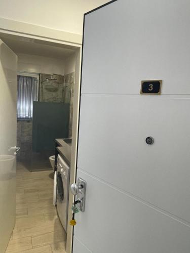 an open door to a kitchen with a refrigerator at S3 Apartment 3 in Margjonaj