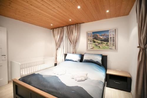 a bedroom with a bed with two stuffed animals on it at Alpina Haus in Oberammergau