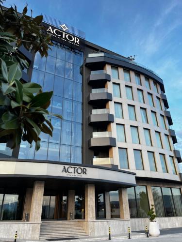 a building with a sign on top of it at Actor Hotel in Skopje