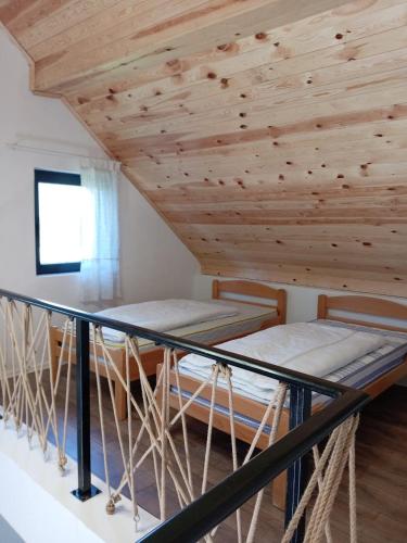 コラシンにあるMountain Mosaic Apartmentsの木製天井のドミトリールームのベッド2台分です。