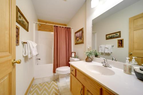 a bathroom with a sink and a toilet at Peaceful Smoky Mountain Cabin with Deck and Fire Pit! in Waynesville