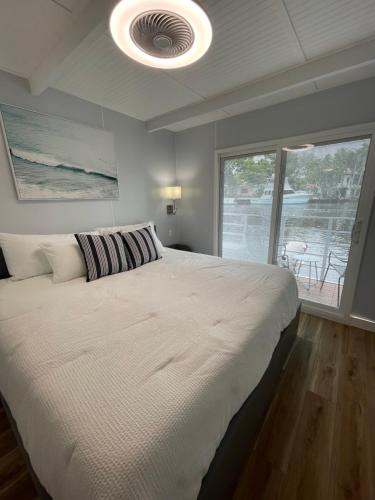 a bedroom with a large bed and a large window at Unique Houseboat Modern and New in Fort Lauderdale