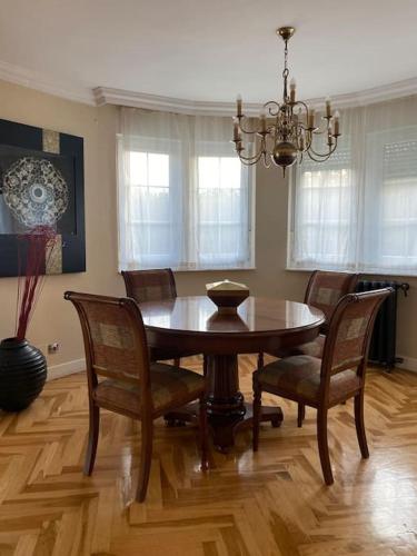 a dining room with a wooden table and chairs at Chalet con Piscina Privada in Santander