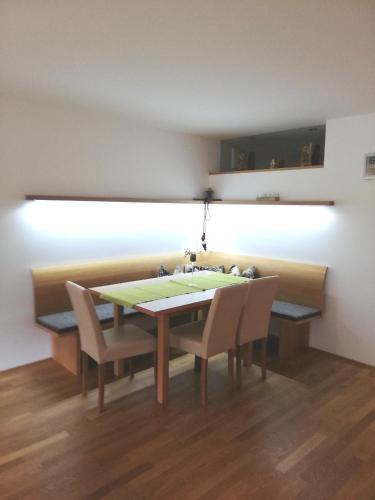 a dining room table with chairs and a sink at Haus Ritter 286 in Schoppernau