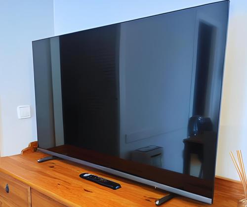 a large flat screen tv sitting on top of a dresser at SunFlower Apartment in Barcelona