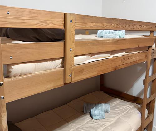 a bunk bed with wooden bunk beds in a room at SunFlower Apartment in Barcelona