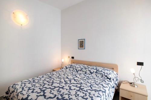 a bedroom with a bed and two night stands at Mirafiori in Alassio