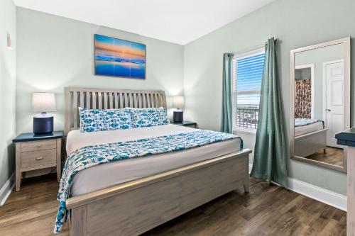 a bedroom with a bed and a window at Laketown Wharf 1817 in Panama City Beach