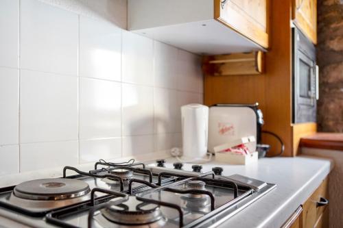 a stove top oven in a small kitchen at Maison Jaccod_piano terra in Morgex