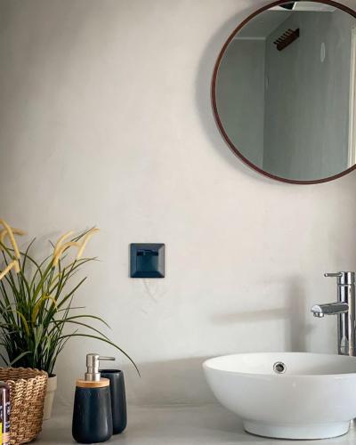 a bathroom with a sink and a mirror on the wall at Akros-cottage on mountain- ground floor in Stavrinídes