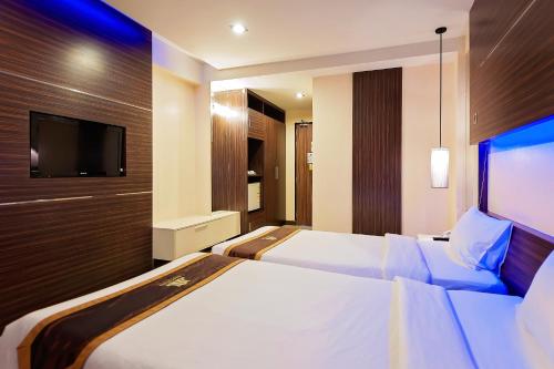 Postel nebo postele na pokoji v ubytování Khon Kaen Hotel