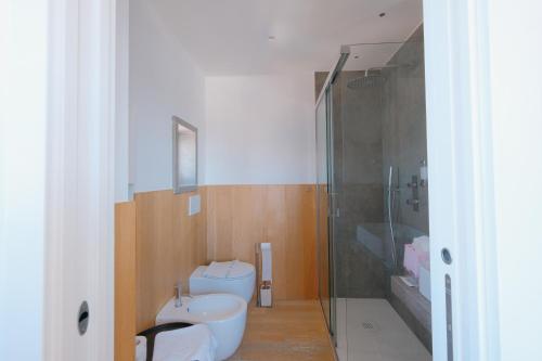 a bathroom with a shower and a toilet and a sink at La Finestrella in Bari