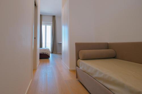 a living room with a couch and a bedroom at La Finestrella in Bari
