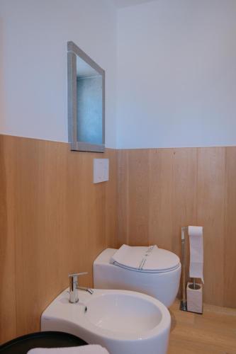 a bathroom with a sink and a toilet and a mirror at La Finestrella in Bari