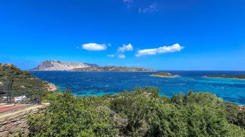a view of the ocean with islands in the distance at Appartamento Mare Nostrum - Vista Mare & A/C in Capo Coda Cavallo