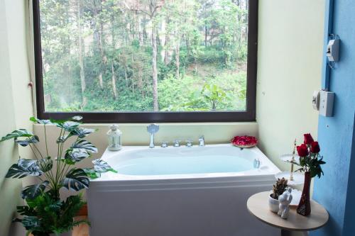 a bath tub in a bathroom with a window at Sapa Friendly Inn Hotel in Sa Pa
