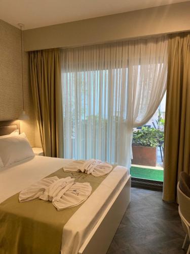 a hotel room with a bed and a window at KUCA URLA in Urla