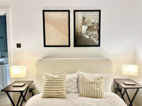 a bedroom with three pictures above a bed at Cozy and Peaceful Apartment with Terrace in Hackney in London