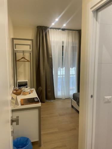 a room with a kitchen and a living room at La Casa di Ily in Naples
