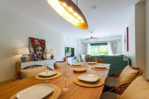 a dining room with a wooden table and chairs at Luxury 3-bed apt Capanes del Golf in Benahavís